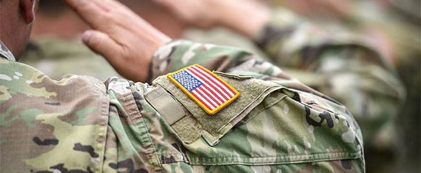 American military in camo saluting